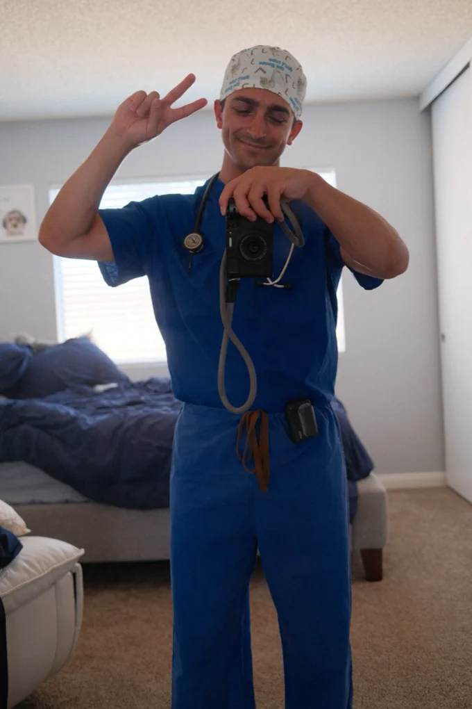 Shaun in scrubs holding a camera
